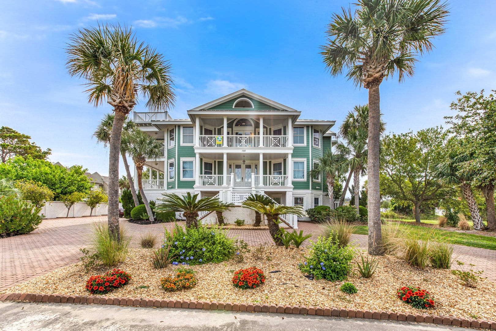 Green house with palm trees.