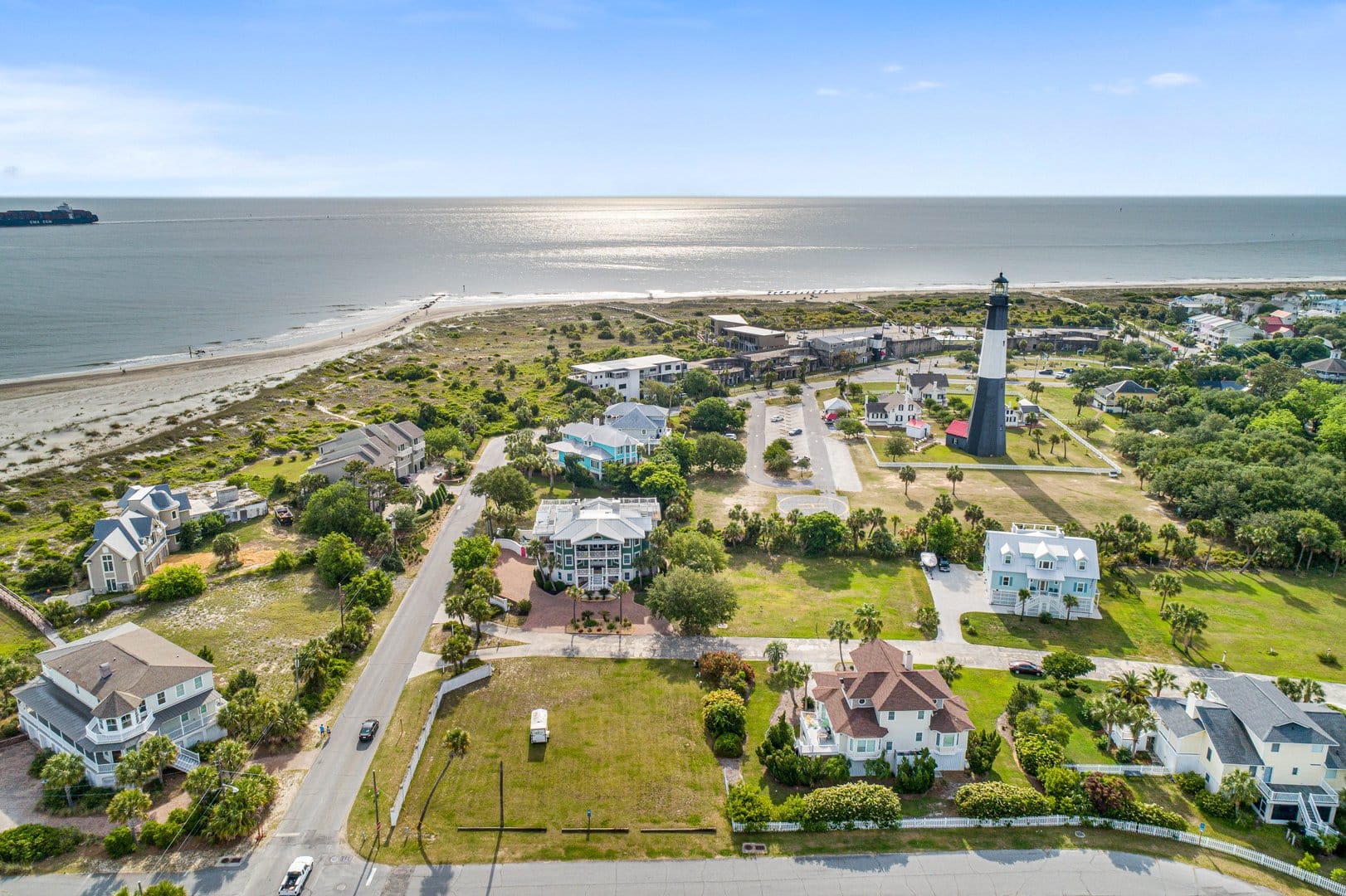 Coastal town with lighthouse, ocean.