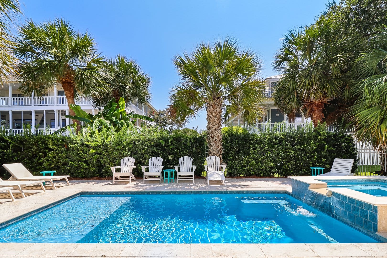 Sunny poolside with palm trees.