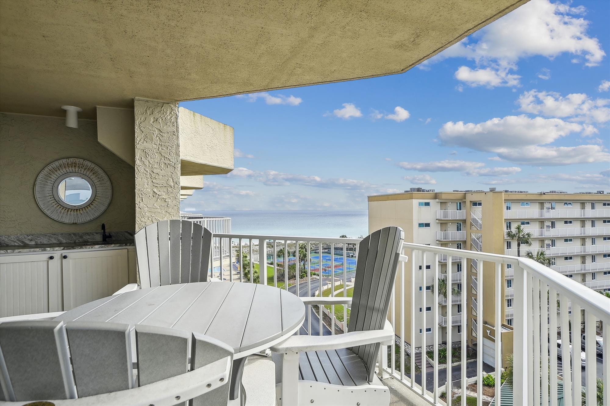 Balcony with ocean view and furniture.