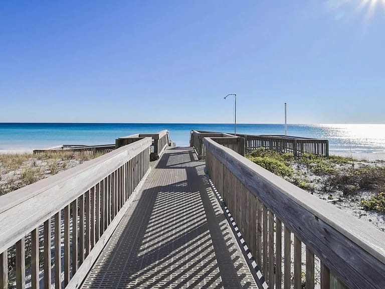 Wooden boardwalk leading to beach.