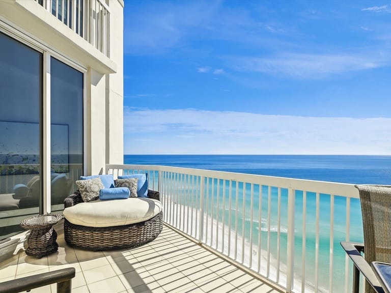 Ocean-view balcony with lounge chair.