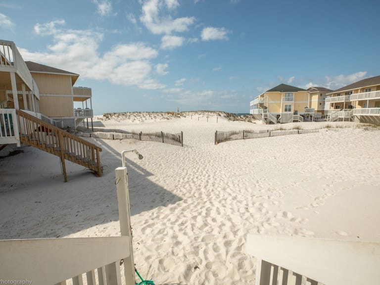 Beach houses and sandy pathway.