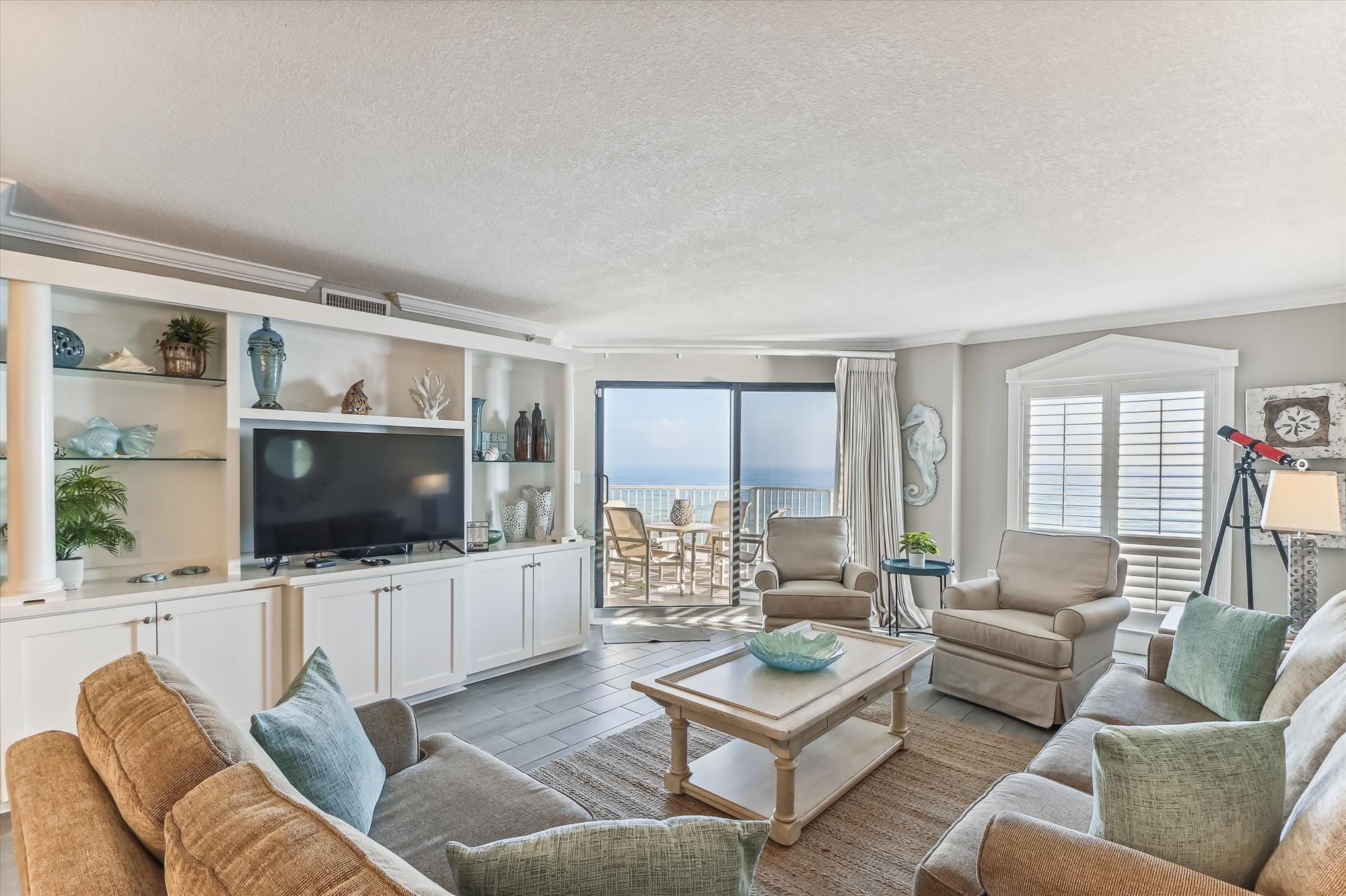 Coastal-themed living room with view.