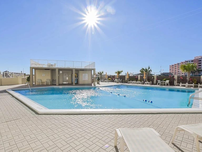 Sunny day at outdoor swimming pool.