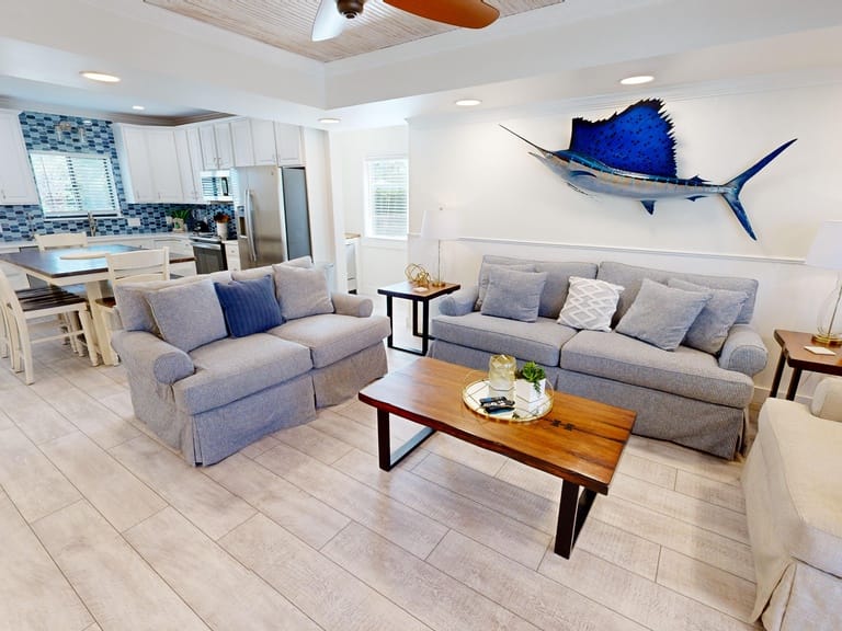 Coastal-themed living room and kitchen.