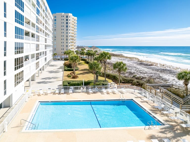 Beachfront hotel with pool, ocean.