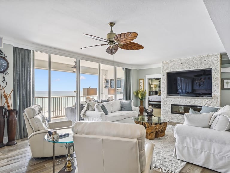 Modern coastal living room, large windows.