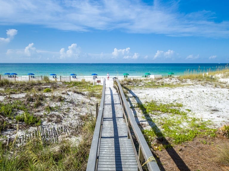 Boardwalk leading to sandy beach.