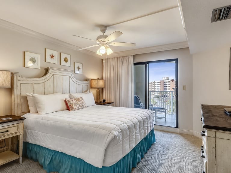 Bedroom with balcony and artwork.