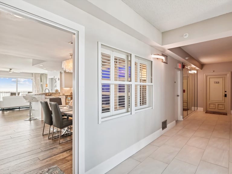 Modern apartment hallway with open kitchen.