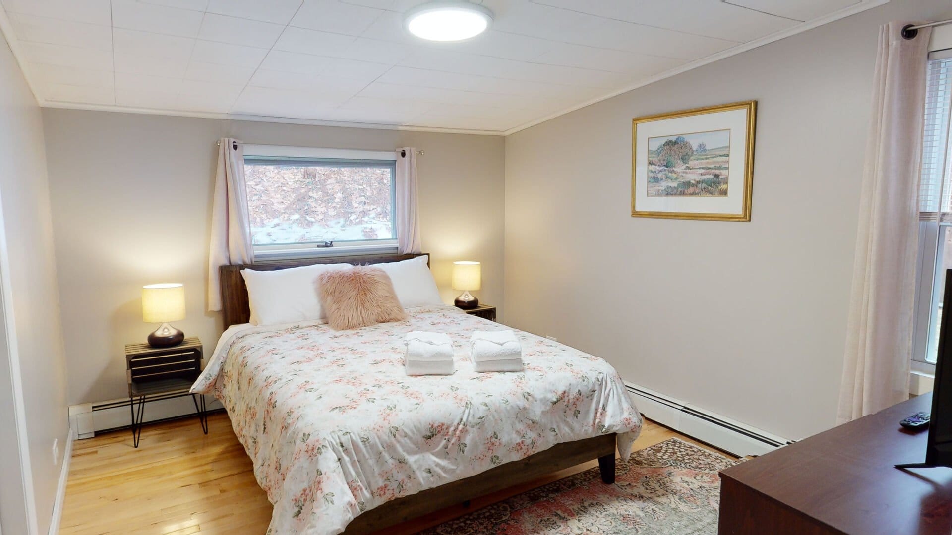 Cozy bedroom with floral bedding.