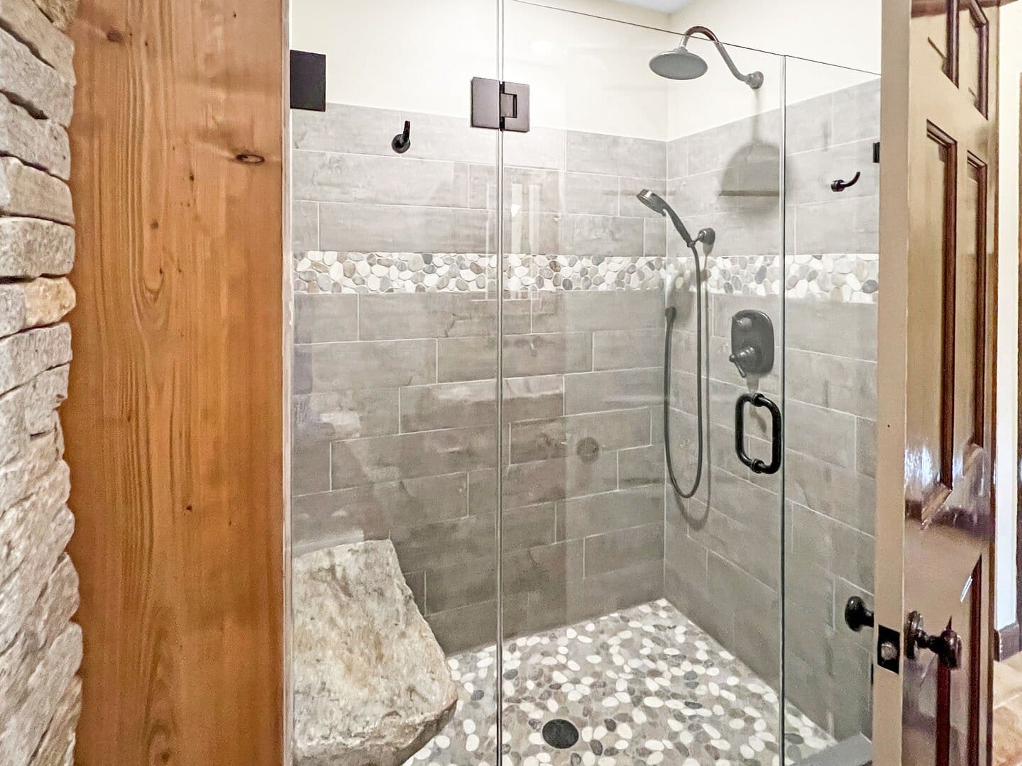 Modern stone-tiled walk-in shower.