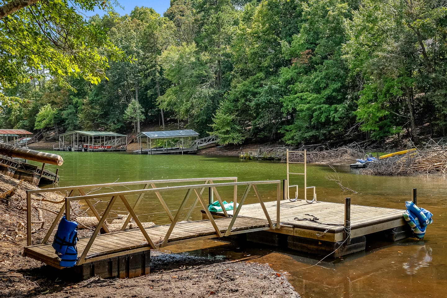 Wooden dock by forested lake.