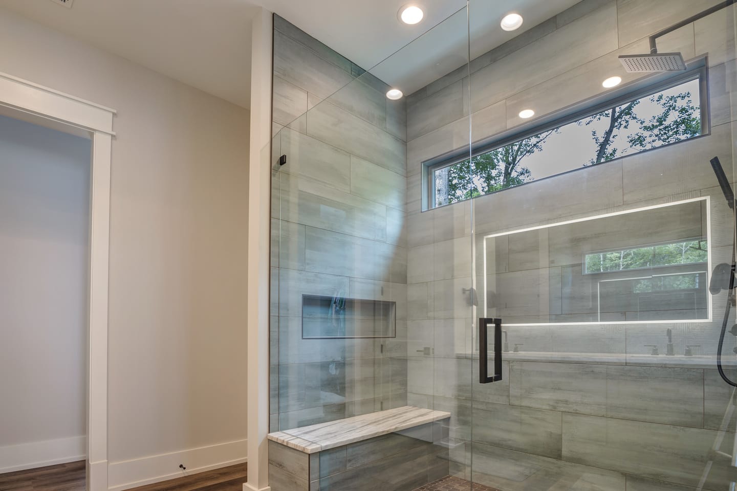 Modern glass shower with bench.