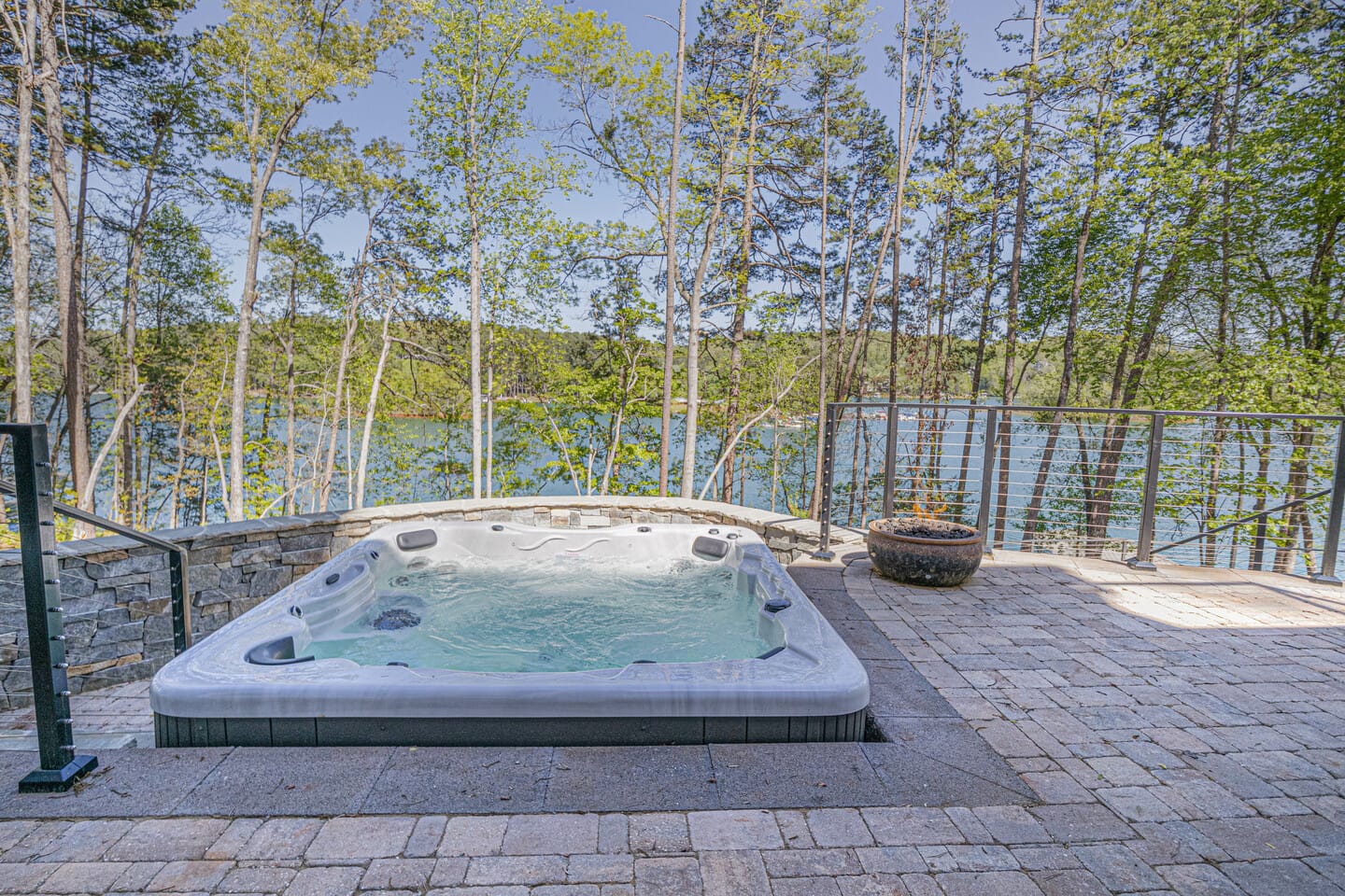 Outdoor hot tub with lake view.