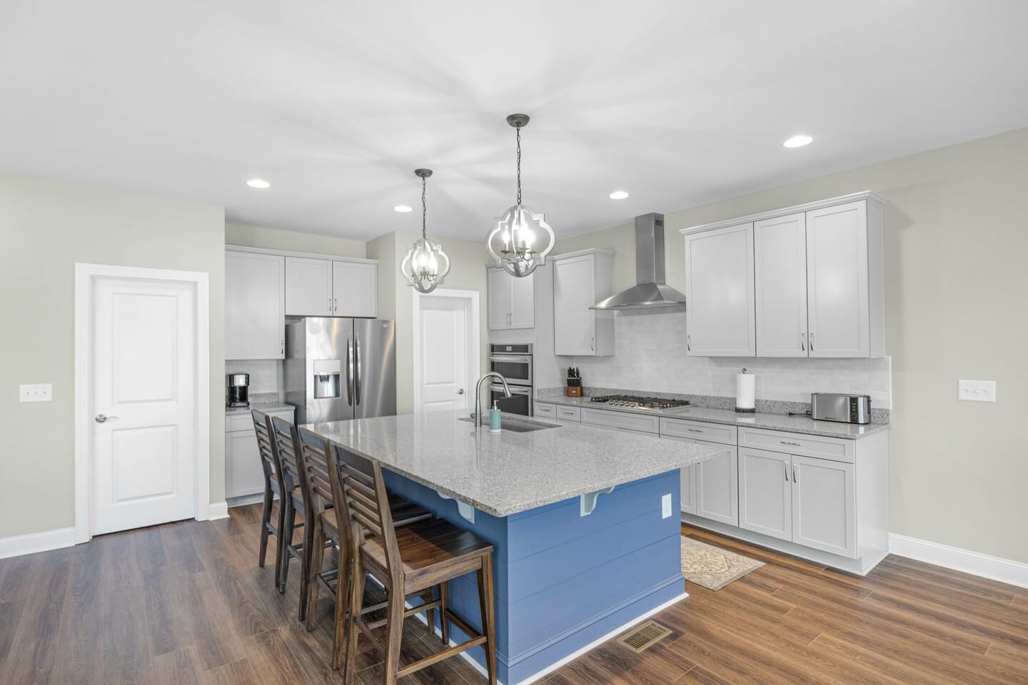 Modern kitchen with island, stools.