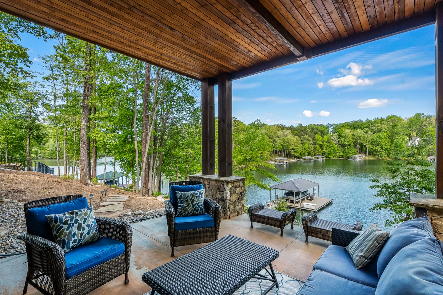 Lakeside patio with outdoor furniture.