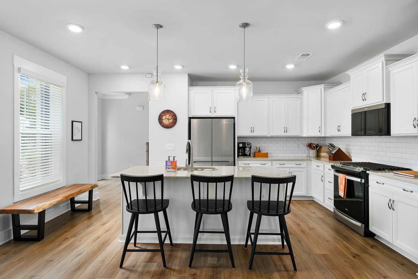 Modern kitchen with island and stools.