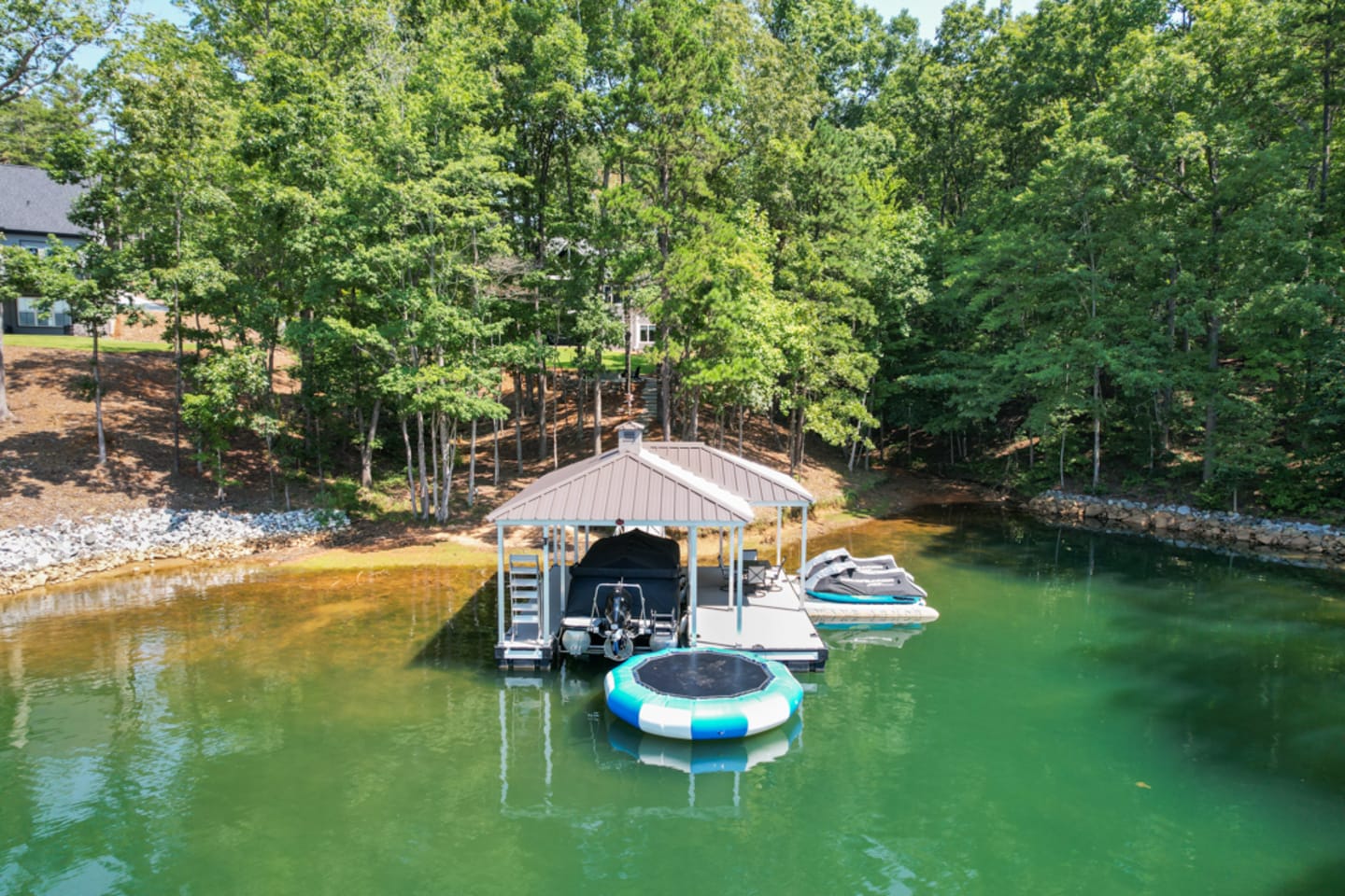 Dock with boat and trampoline.