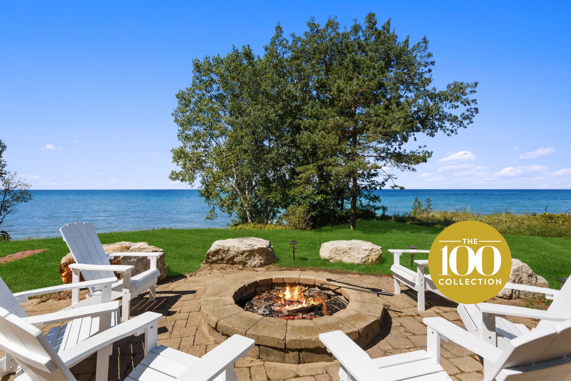 Firepit with chairs by lake.