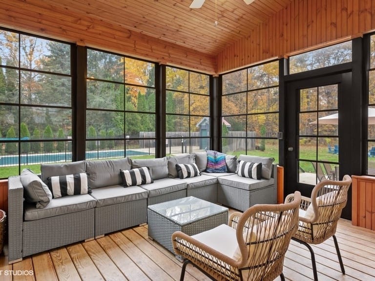 Enclosed patio with wicker furniture.