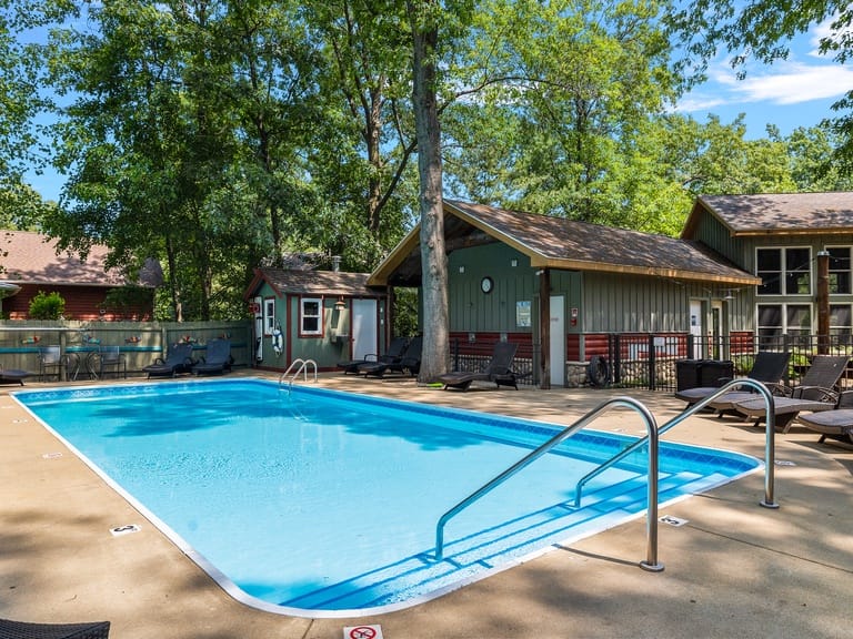 Outdoor pool with surrounding trees.