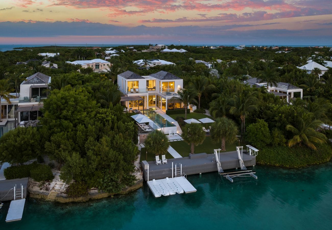 Luxurious waterfront villa at sunset.