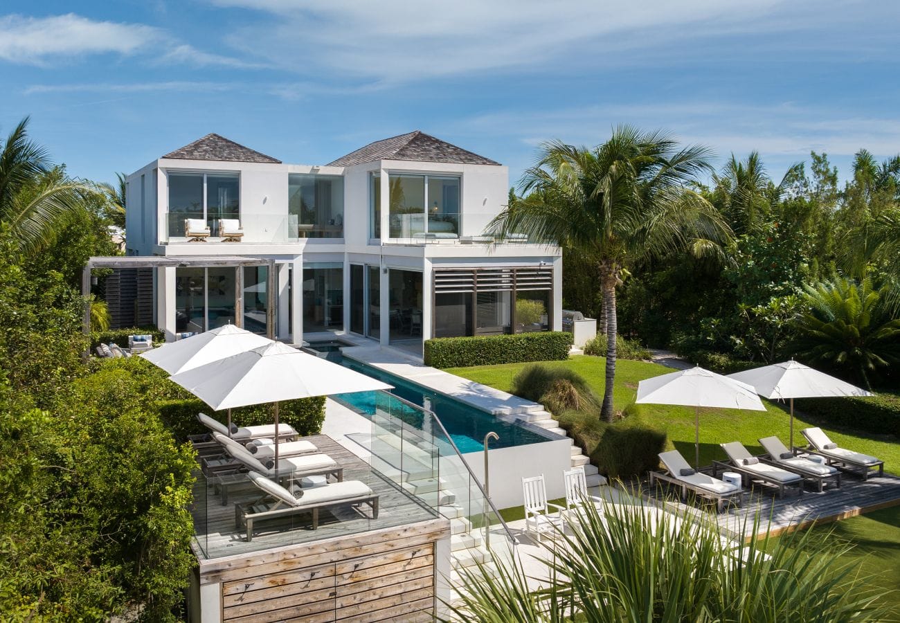 Modern villa with pool and palm.