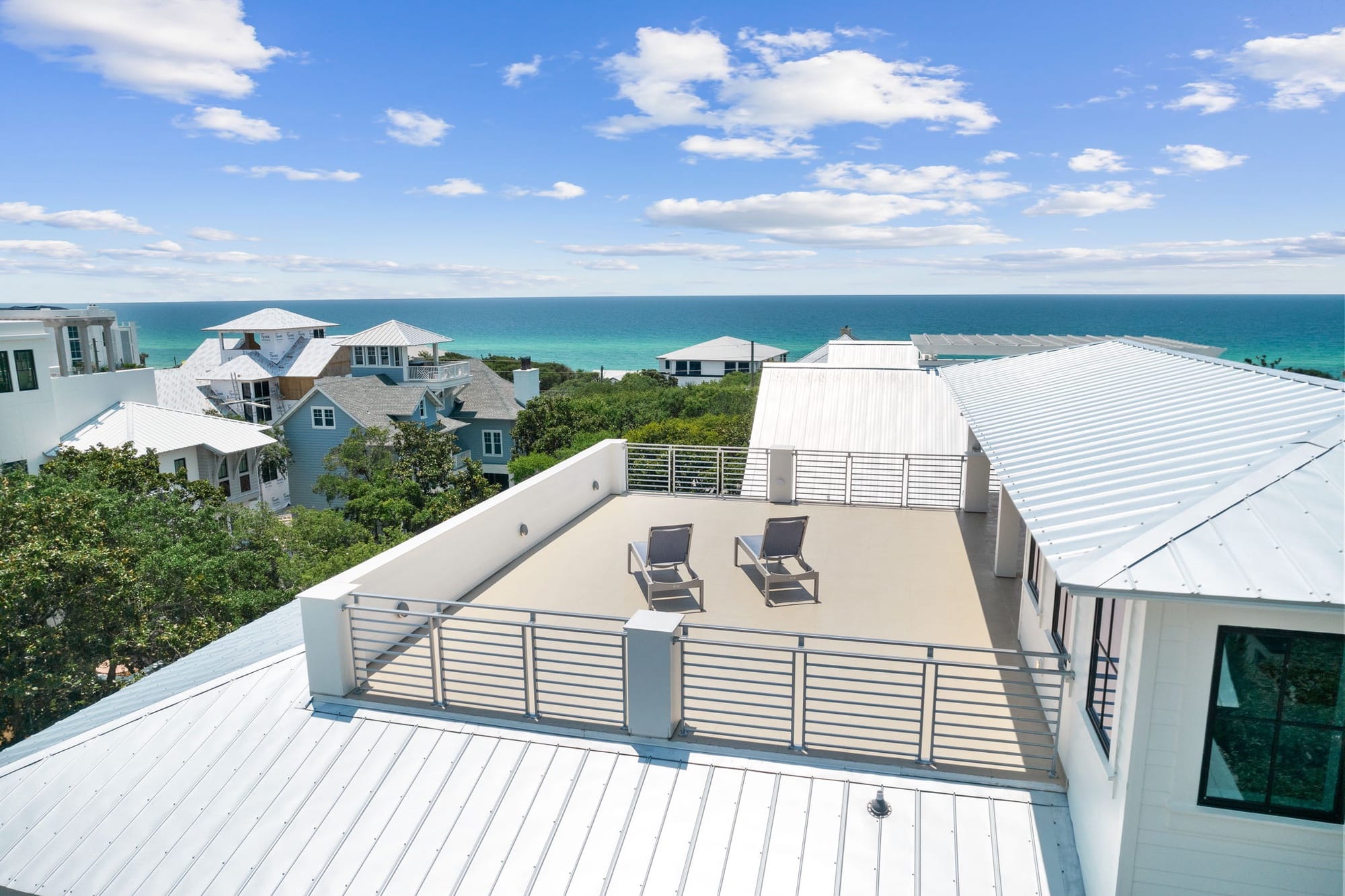 Oceanview rooftop with lounge chairs.