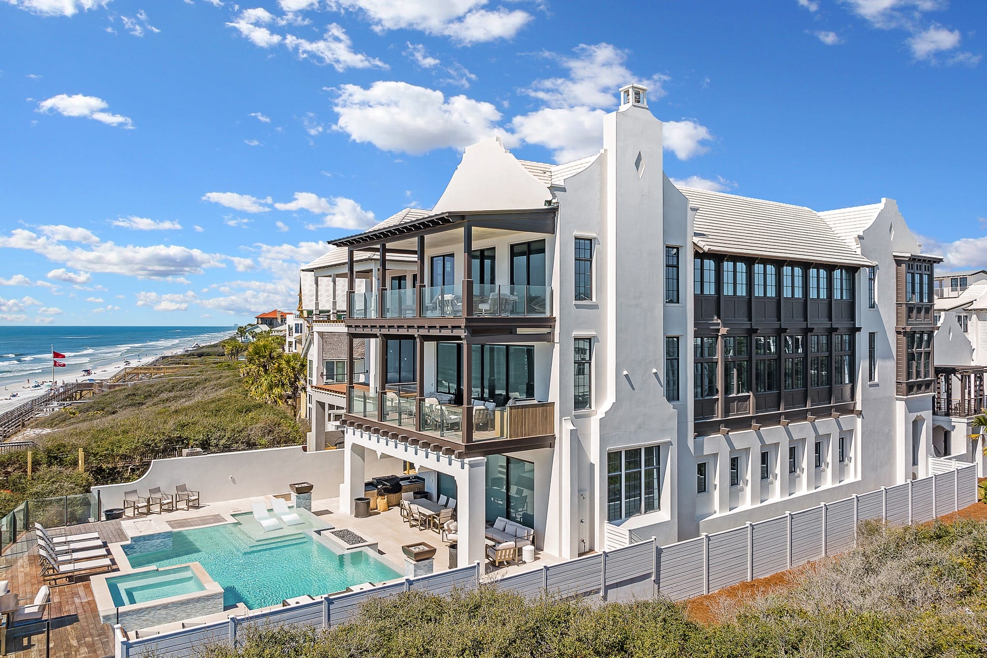 Beachfront mansion with pool, ocean.