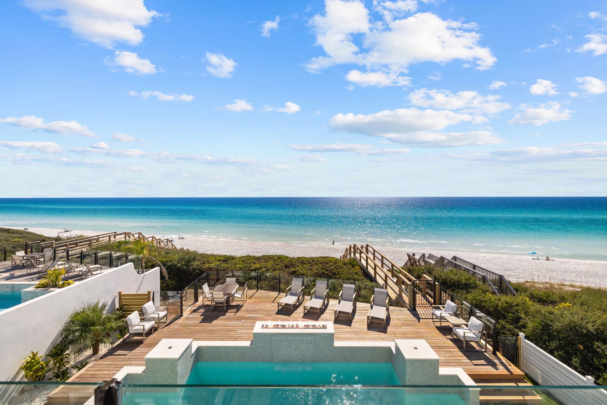 Pool and beach view, sunny day.