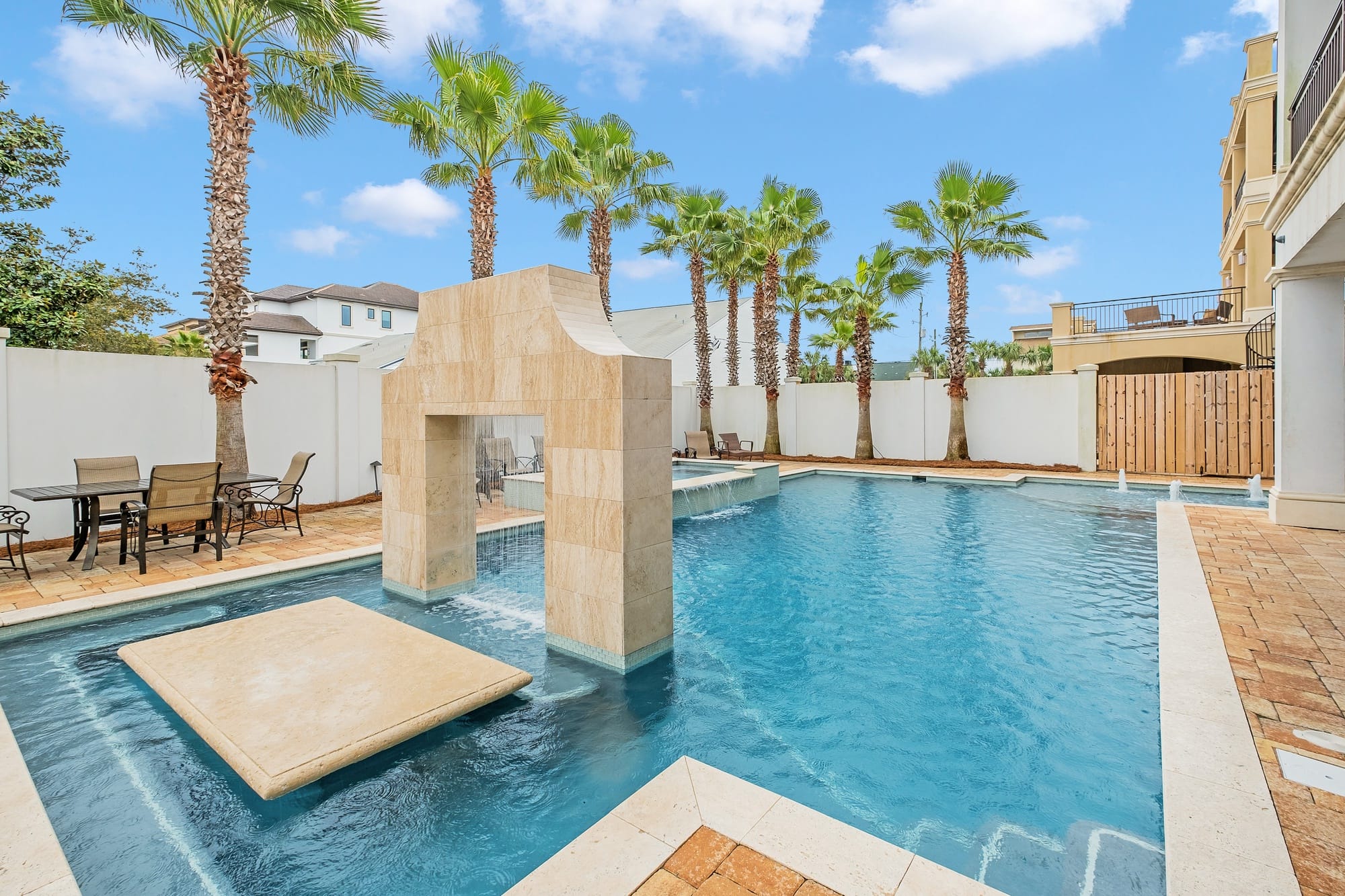 Outdoor pool with palm trees.