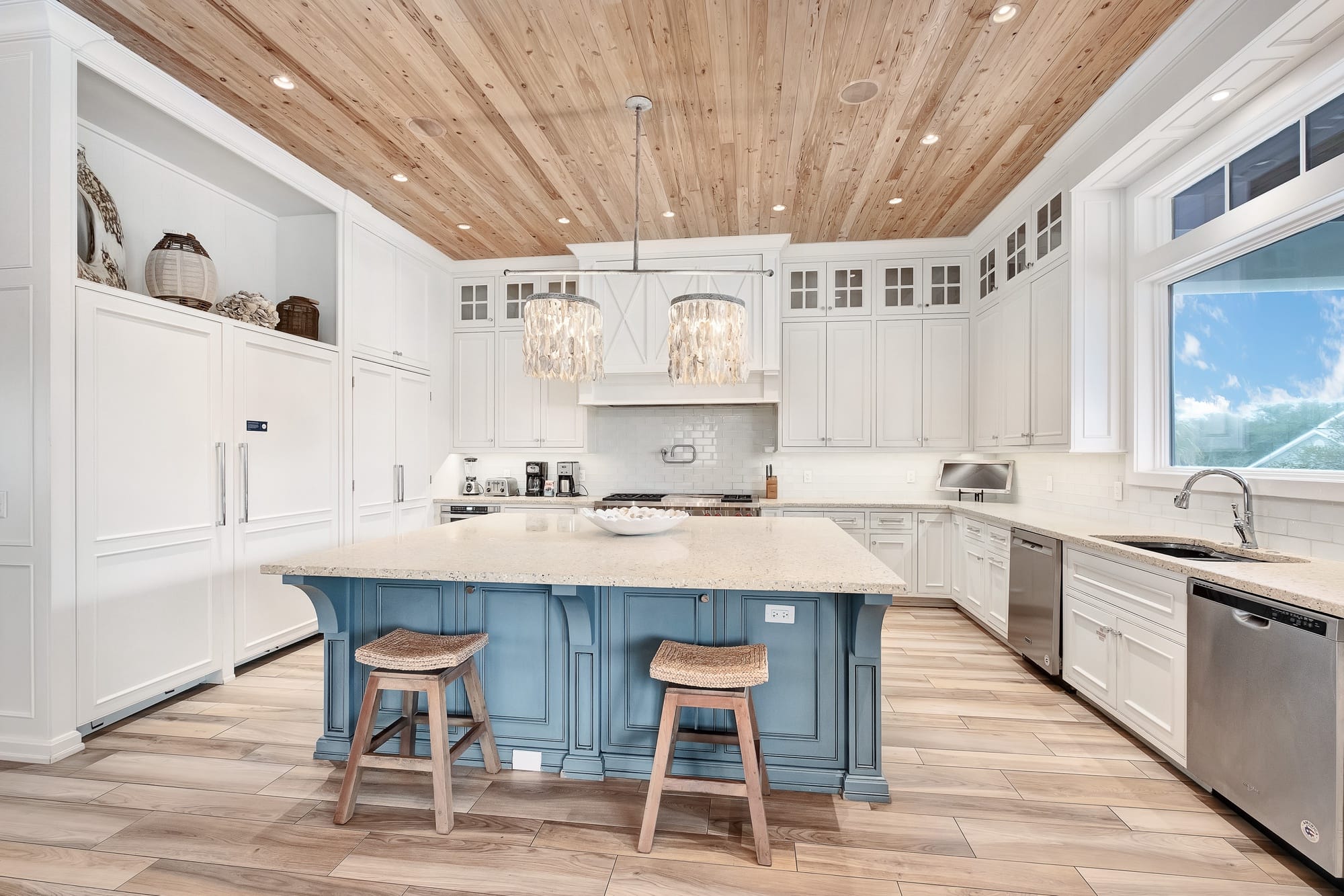 Spacious kitchen with island, stools.