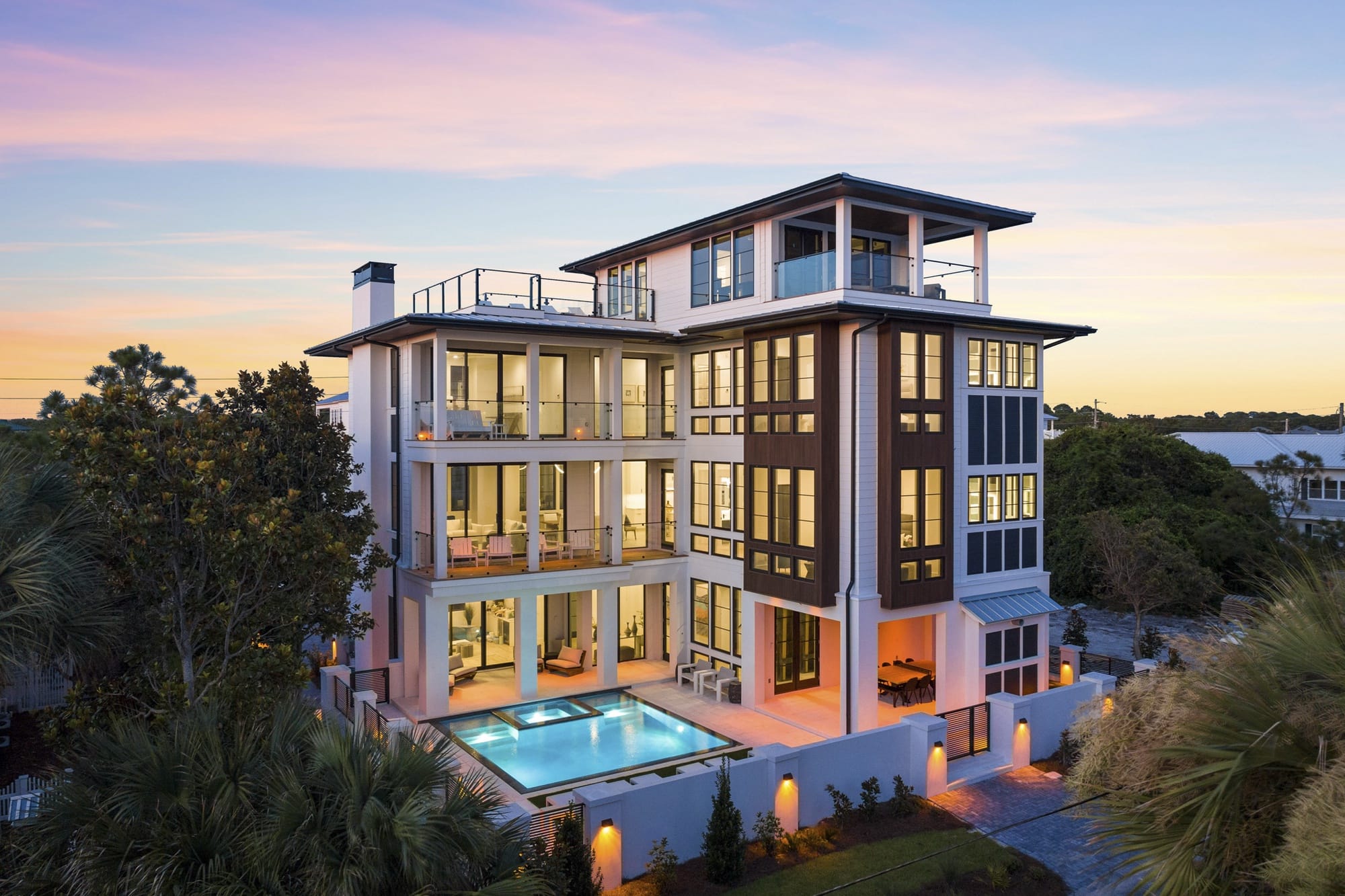 Modern house with illuminated pool.