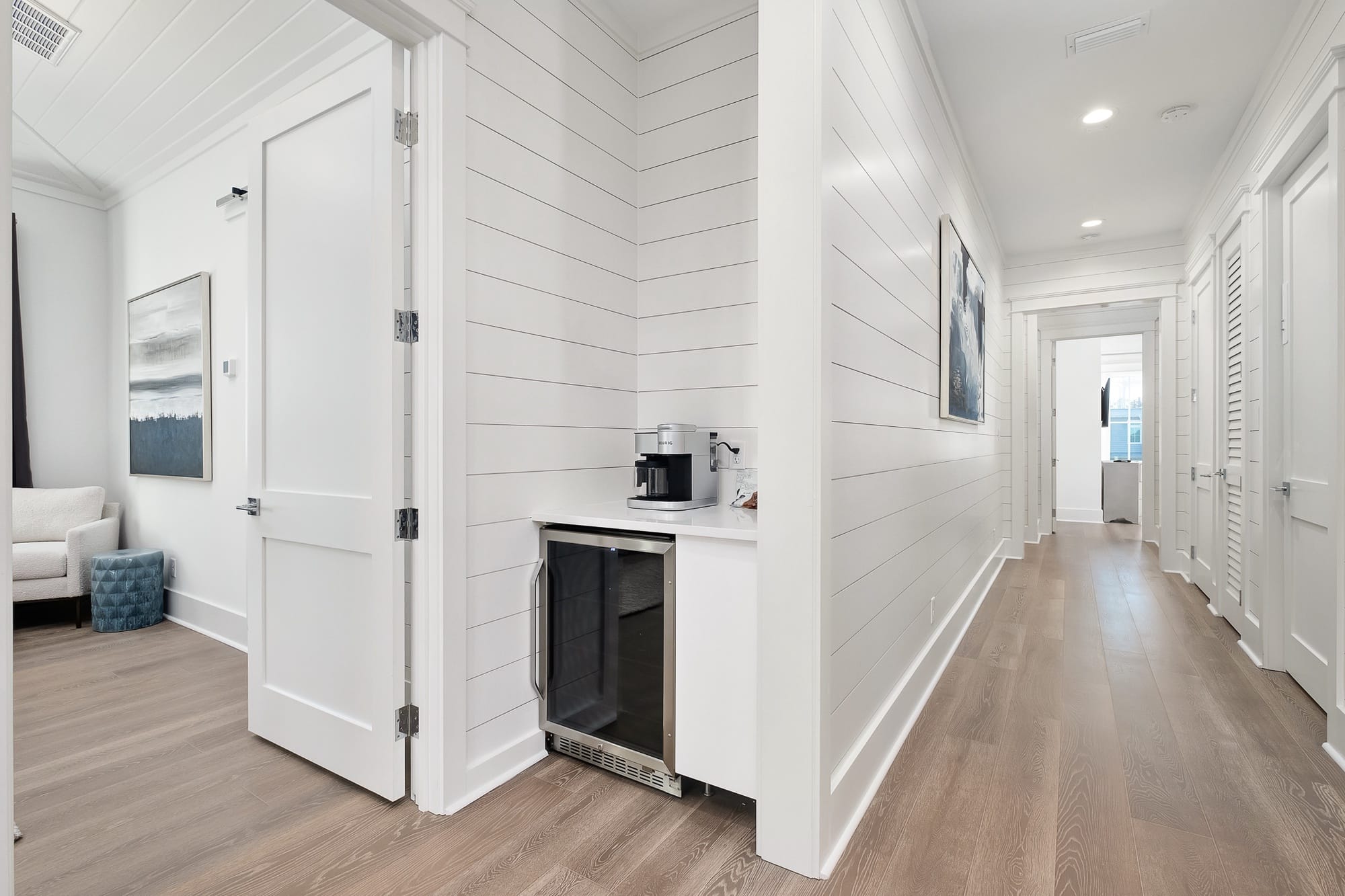 White hallway with coffee maker corner.