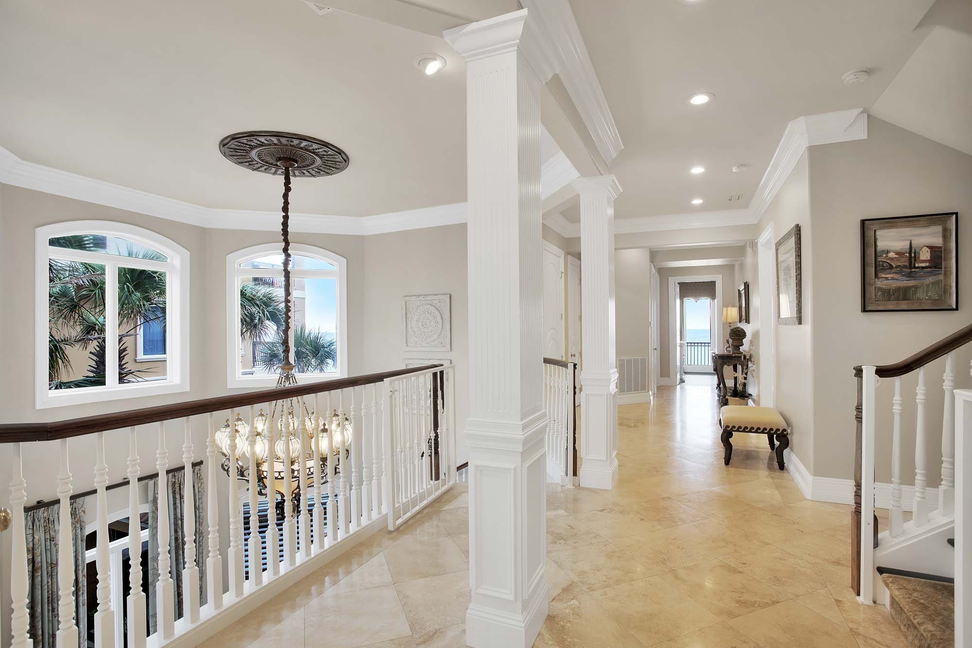 Elegant hallway with large windows.