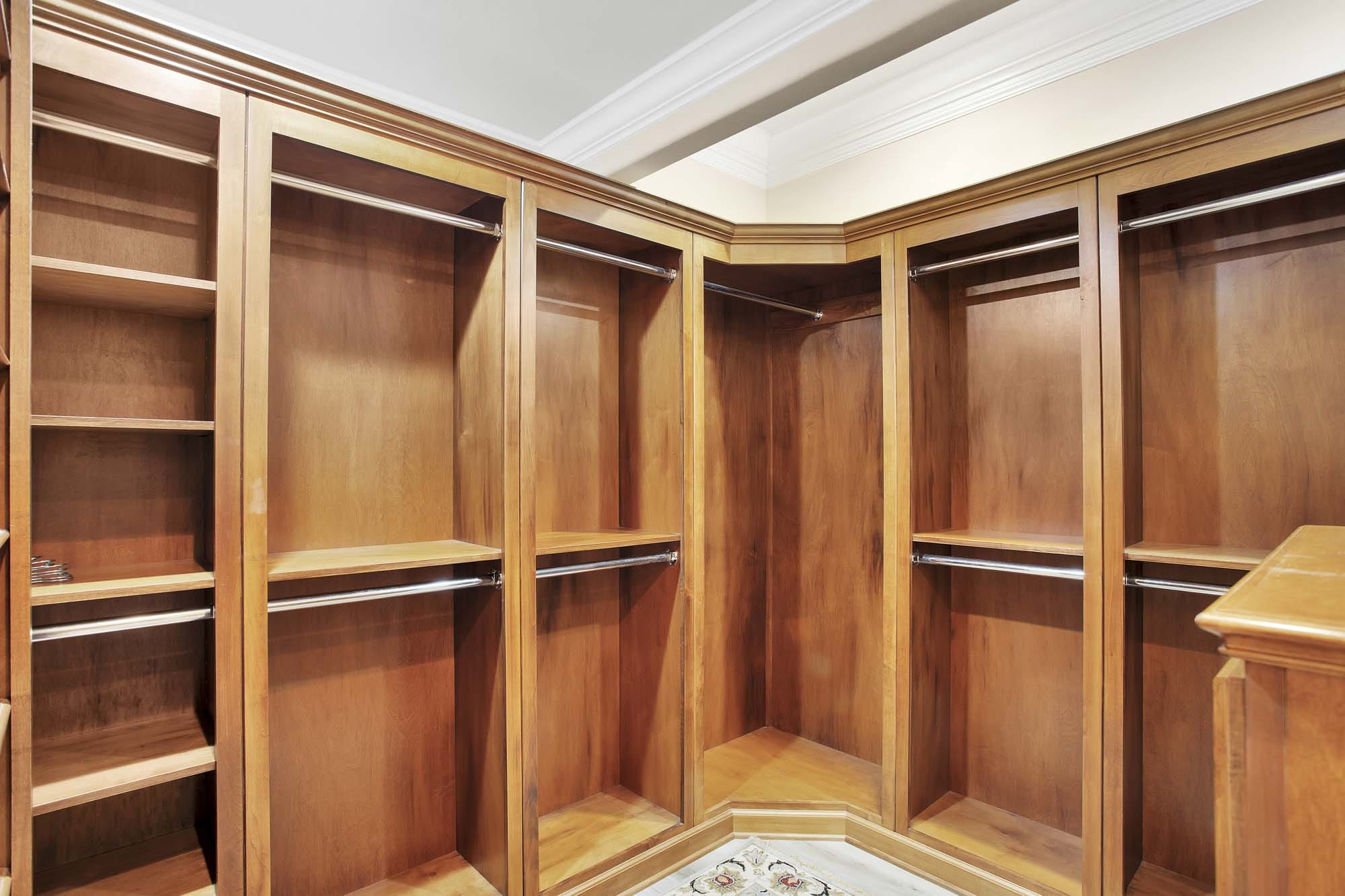 Empty wooden walk-in closet.