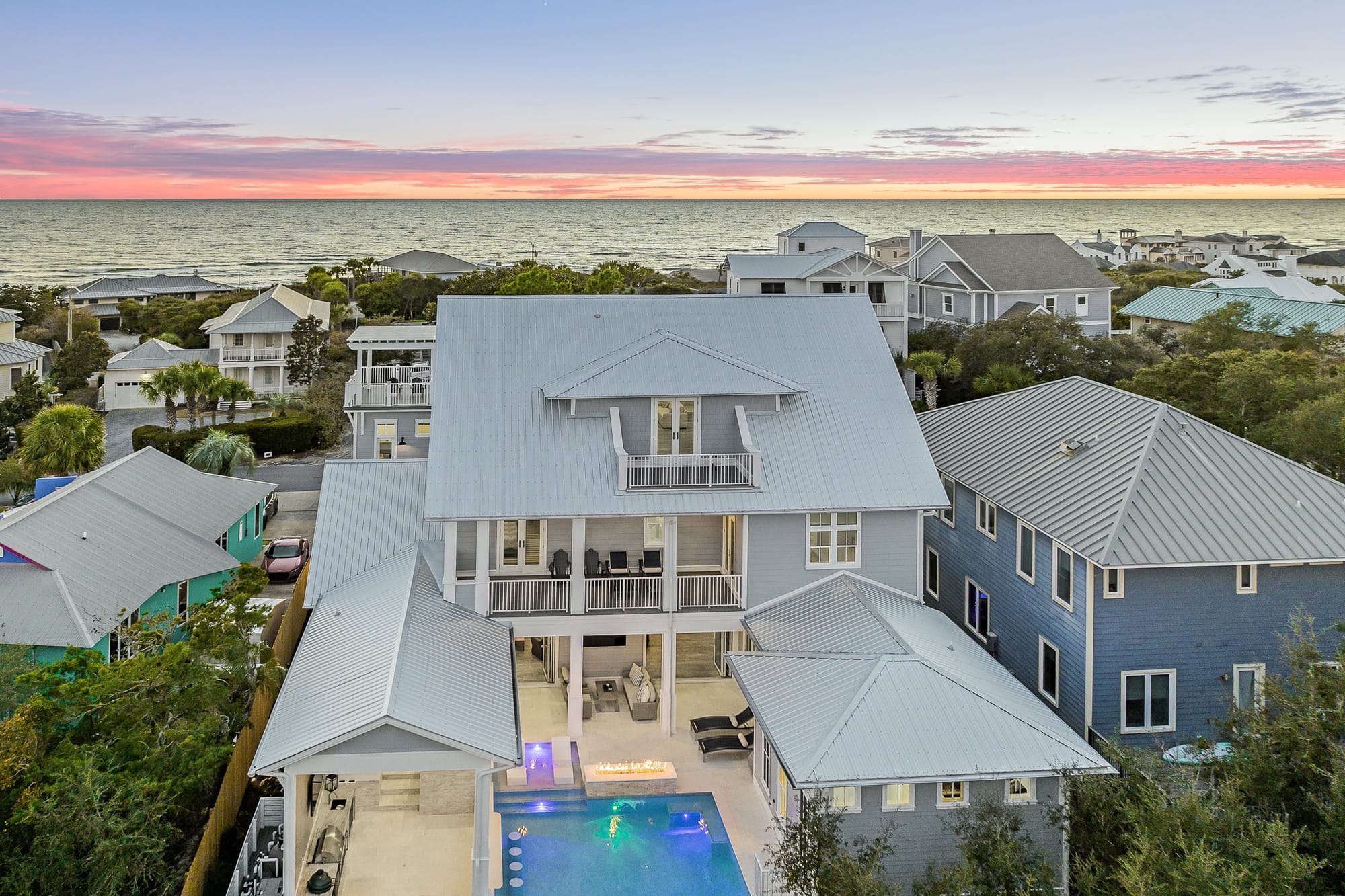 Modern beachfront house at sunset.