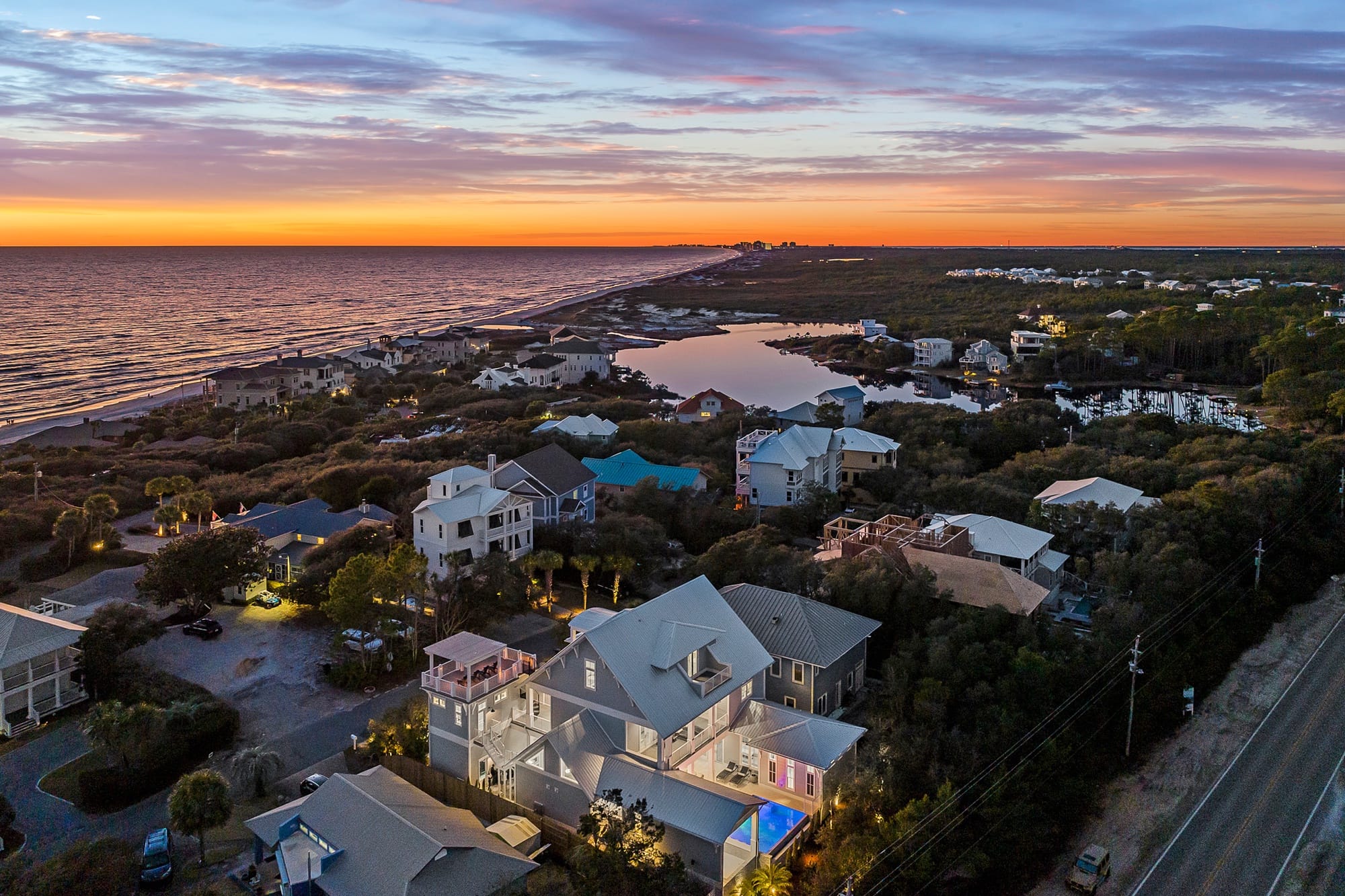 Coastal town at sunset, aerial view.