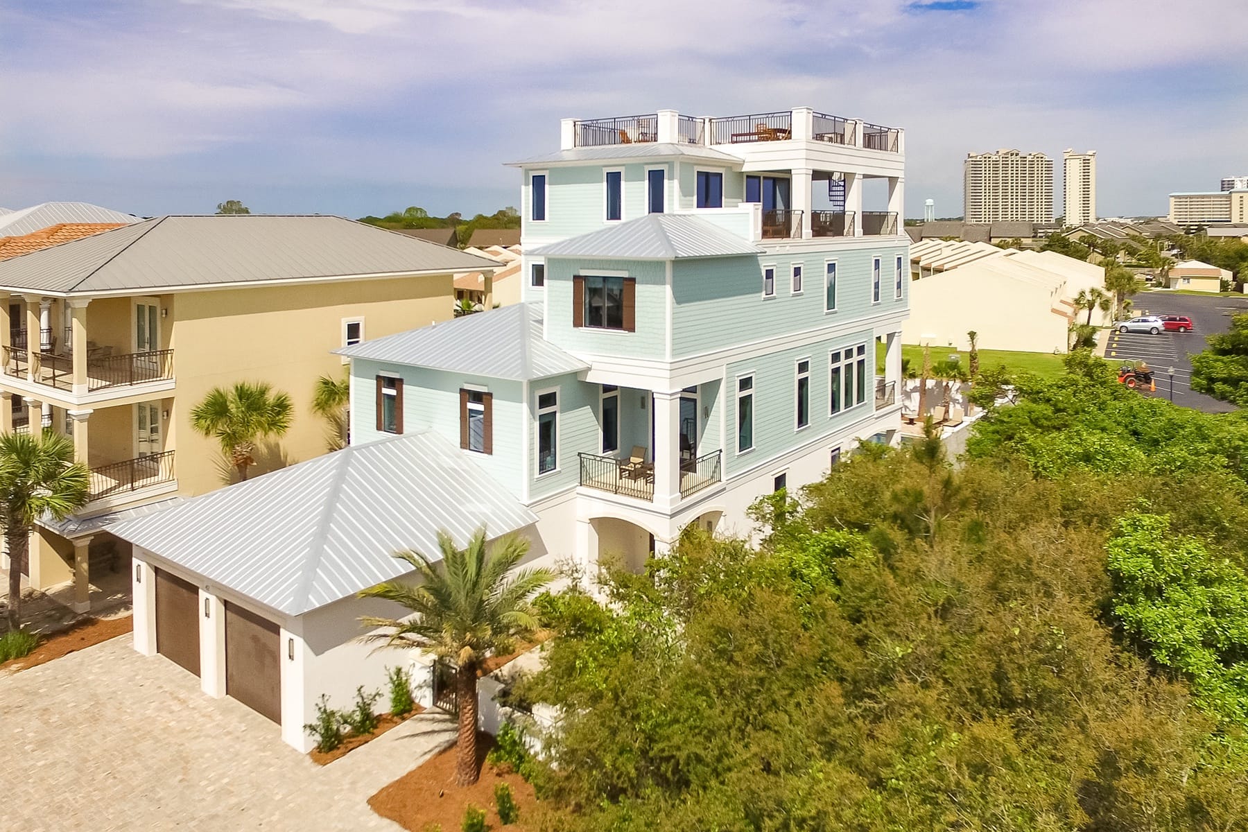 Modern multi-story house with balconies.