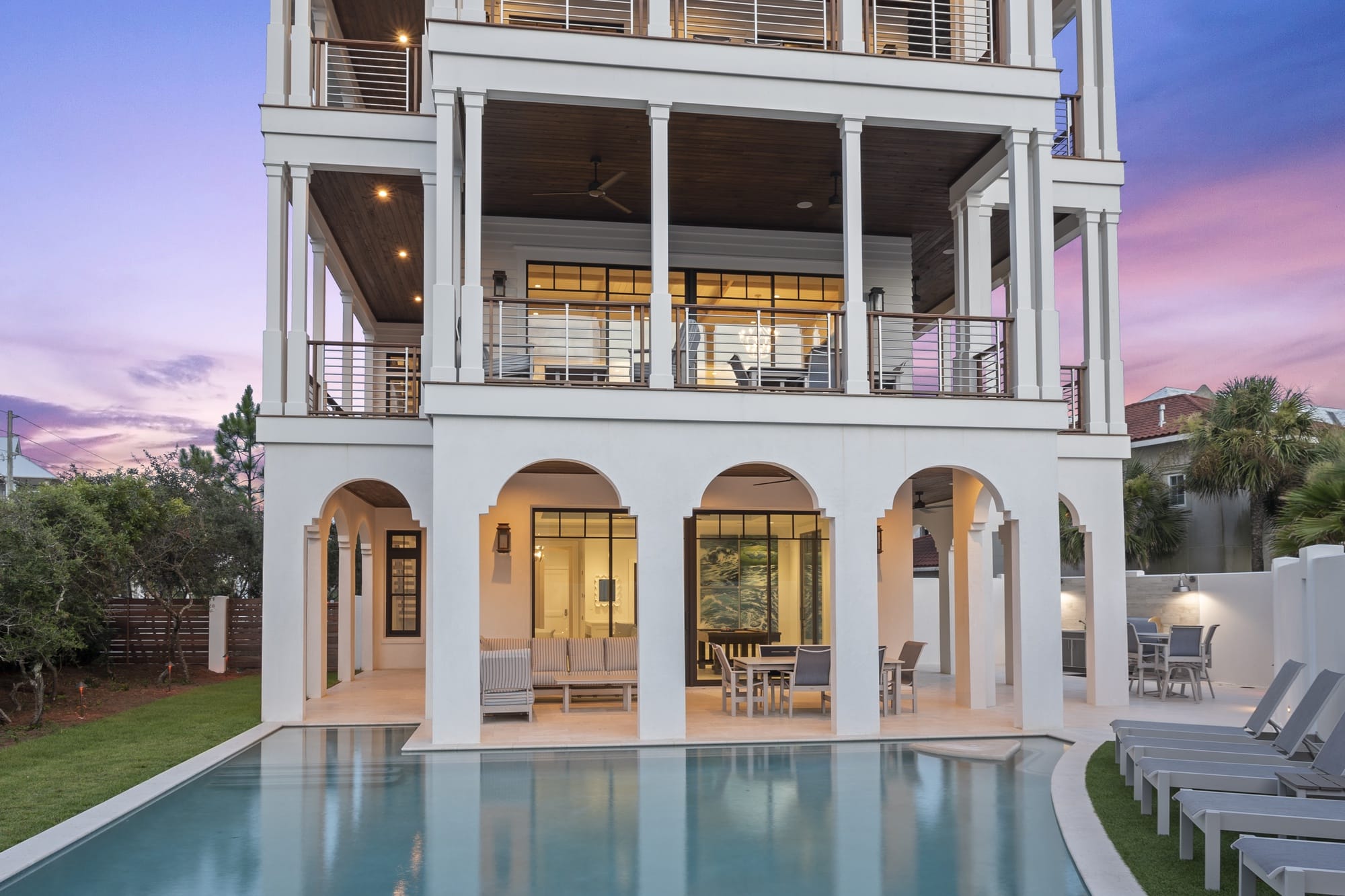 Modern house with pool at sunset.