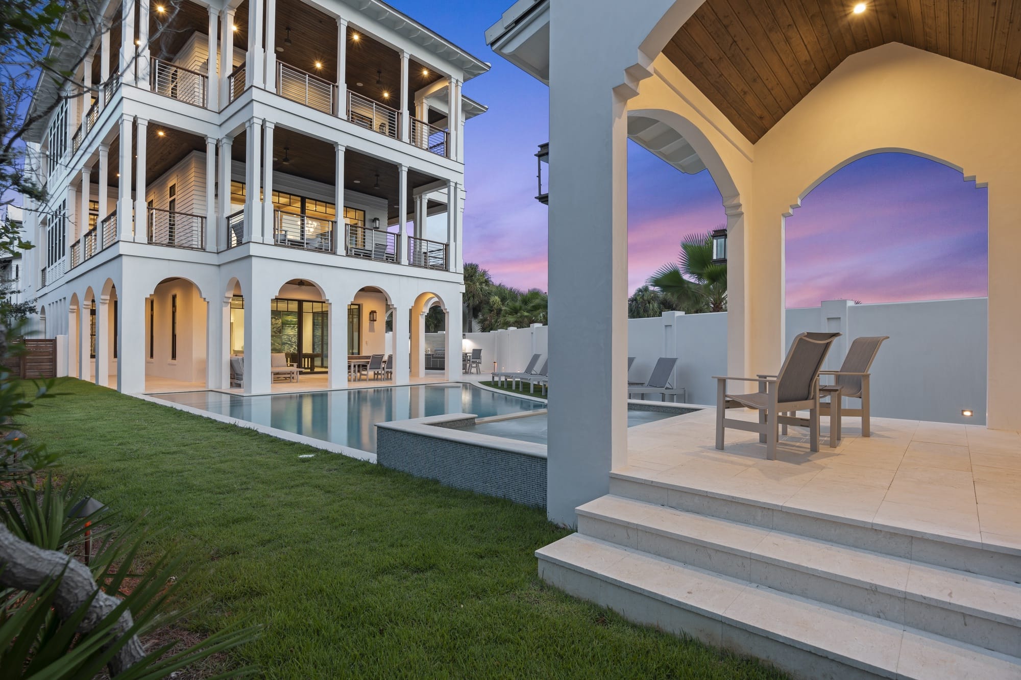 Luxury house with pool at sunset.