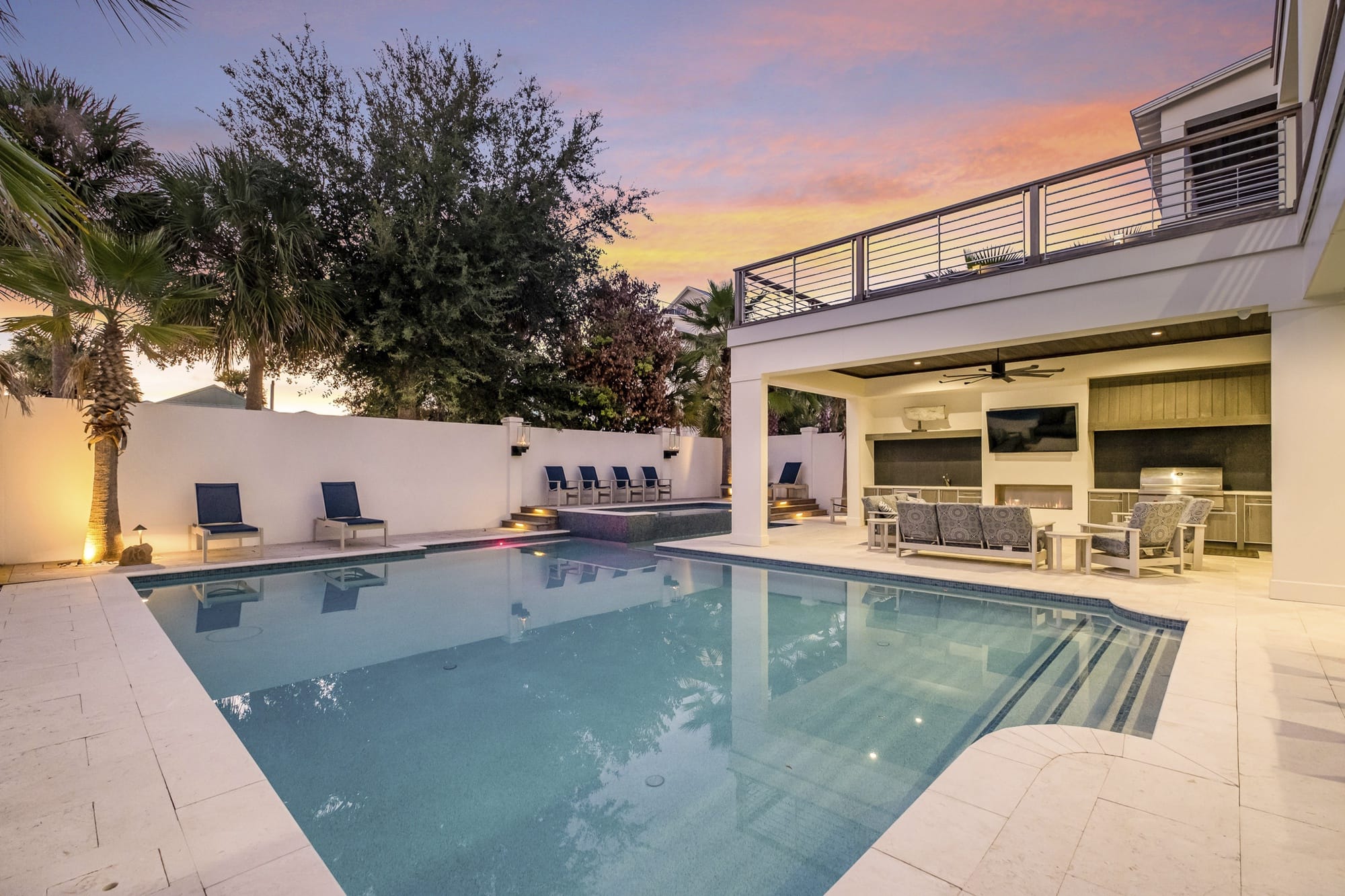 Modern backyard with pool at sunset.