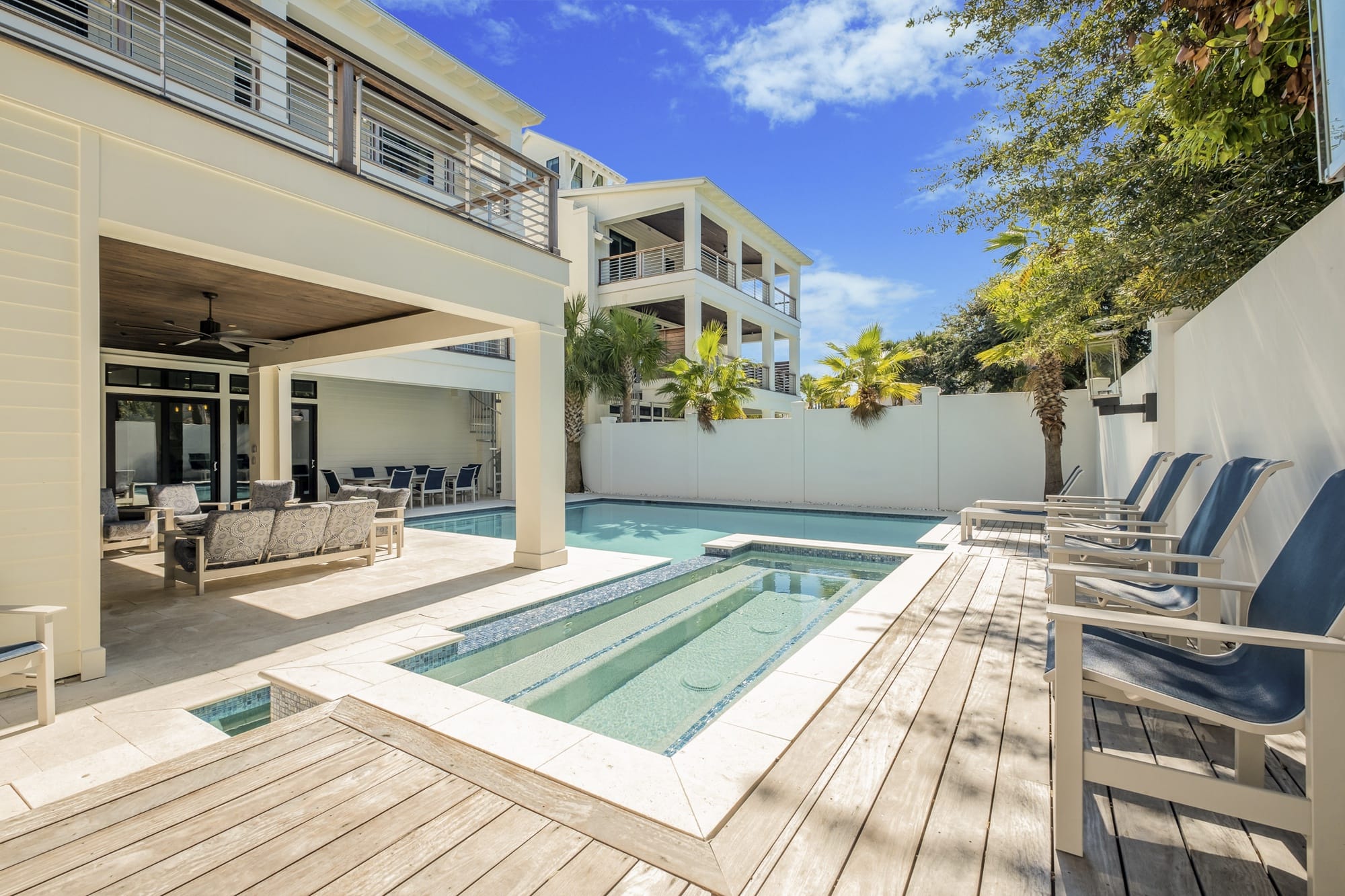 Modern patio with pool, chairs.