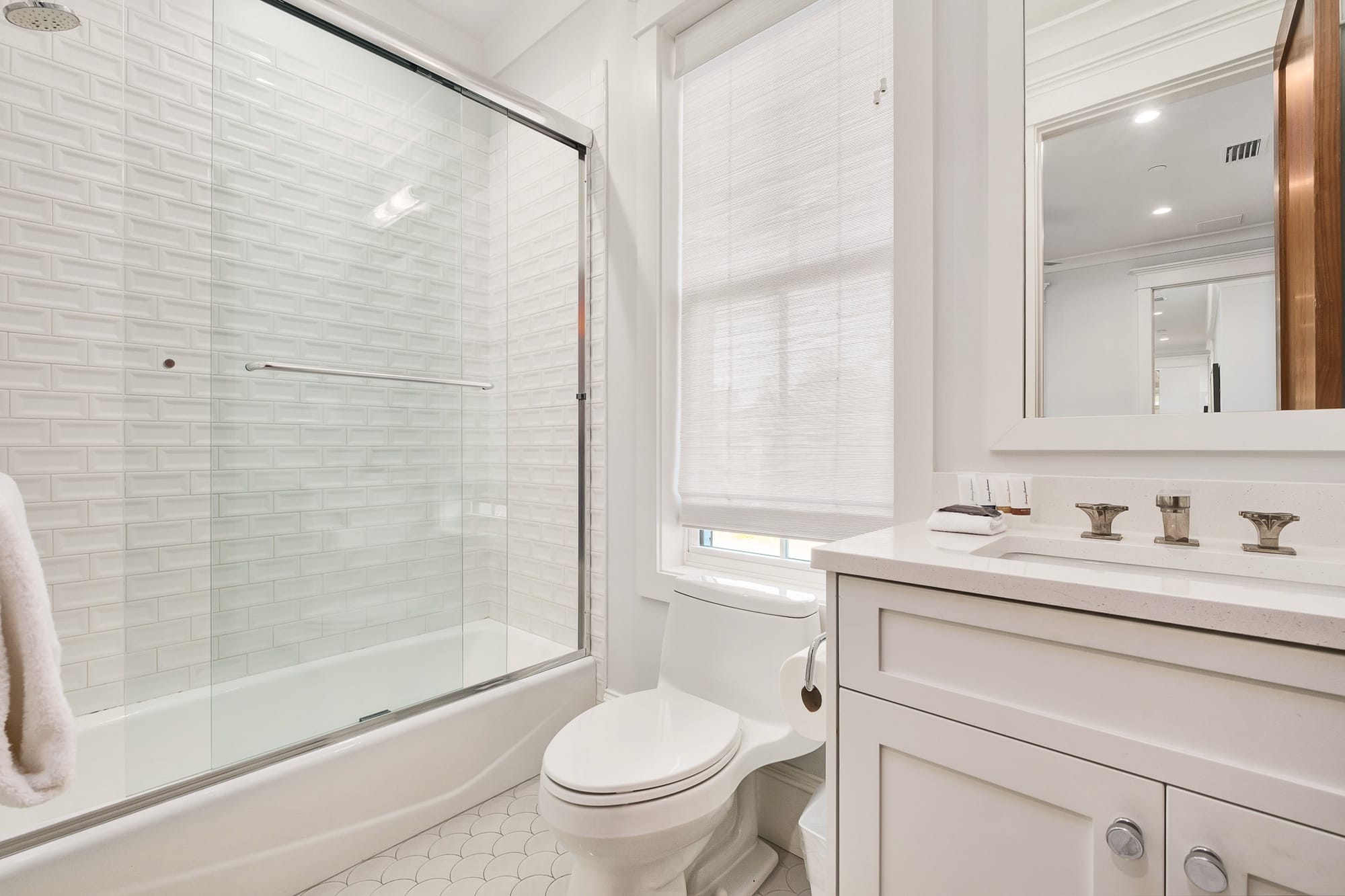 Modern bathroom with shower and toilet.