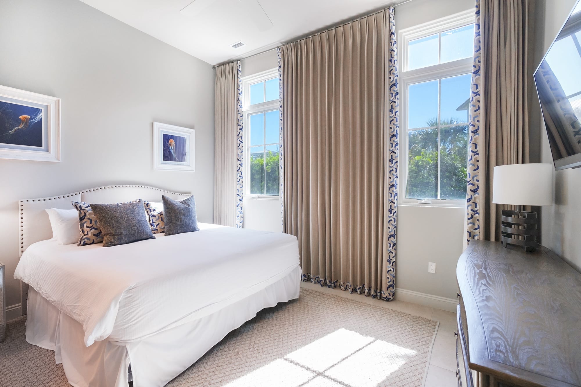 Bright bedroom with large windows.