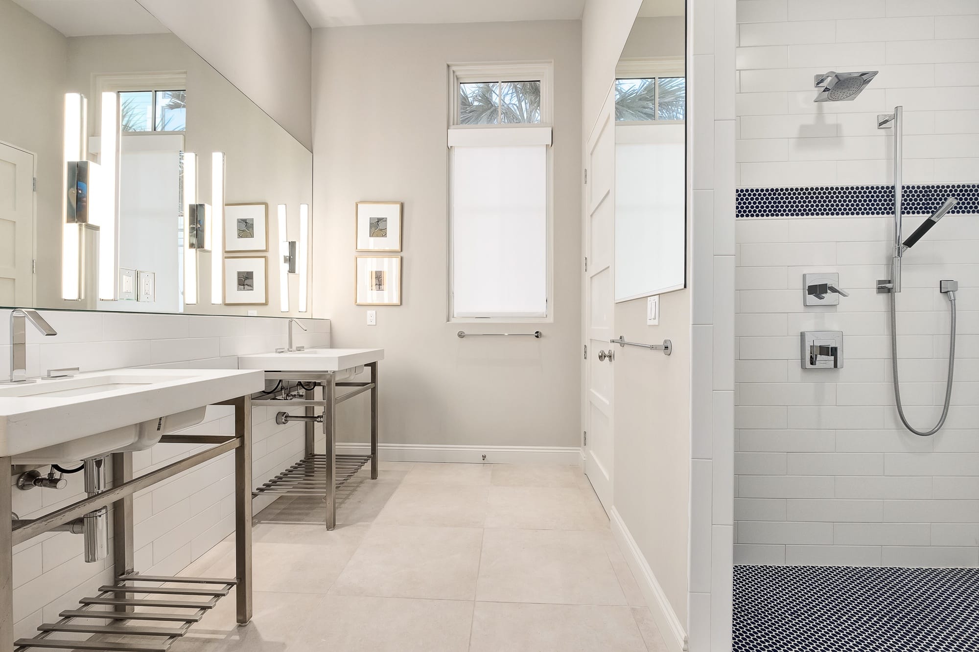 Modern bathroom with shower and sinks.