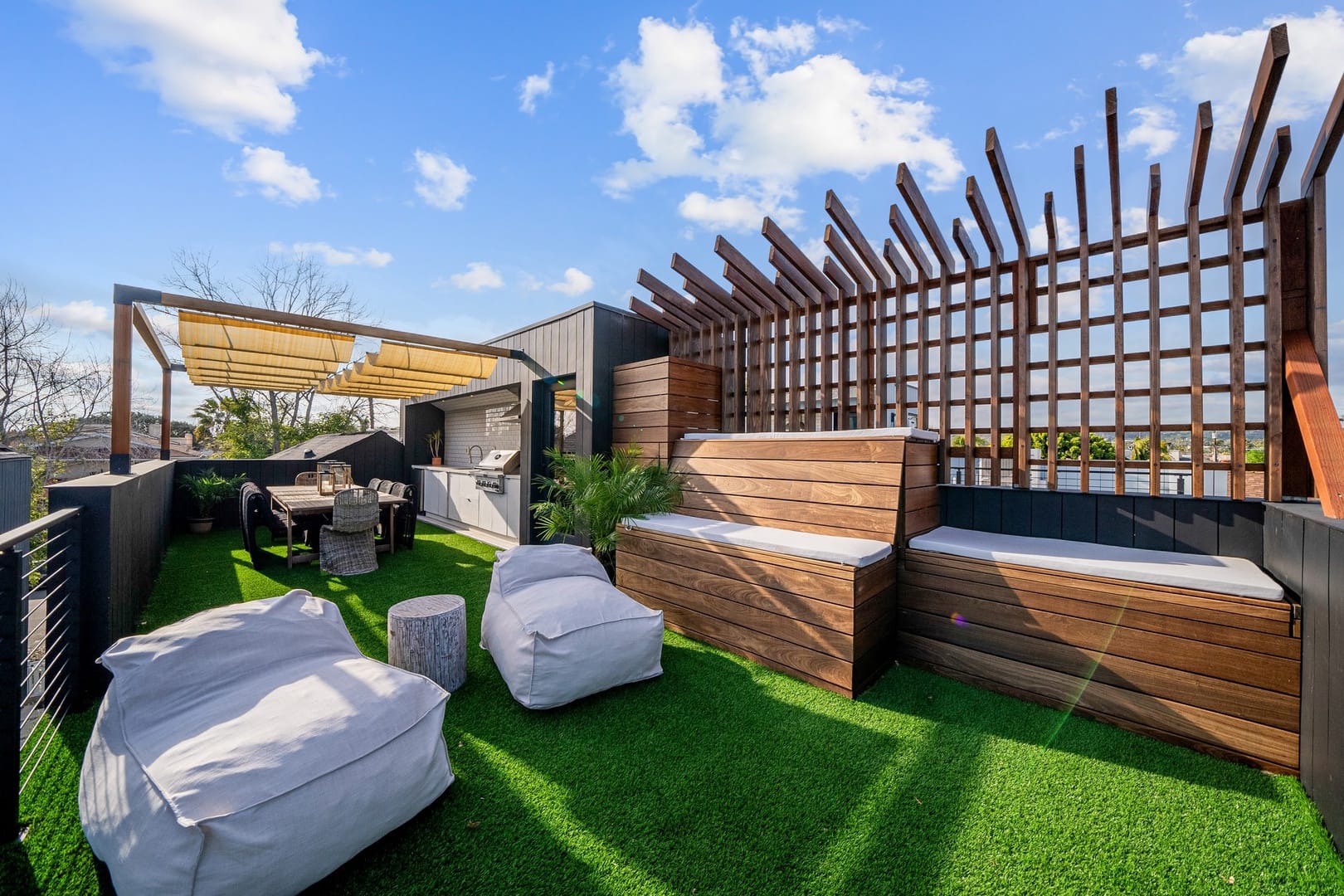 Stylish rooftop with seating, greenery.