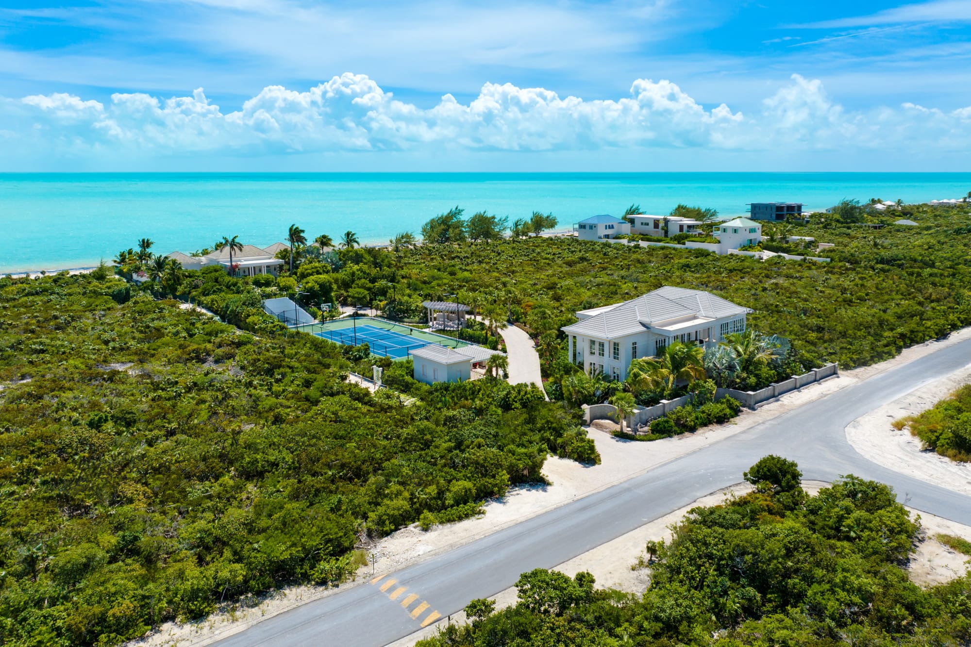 Coastal estate with tennis court.